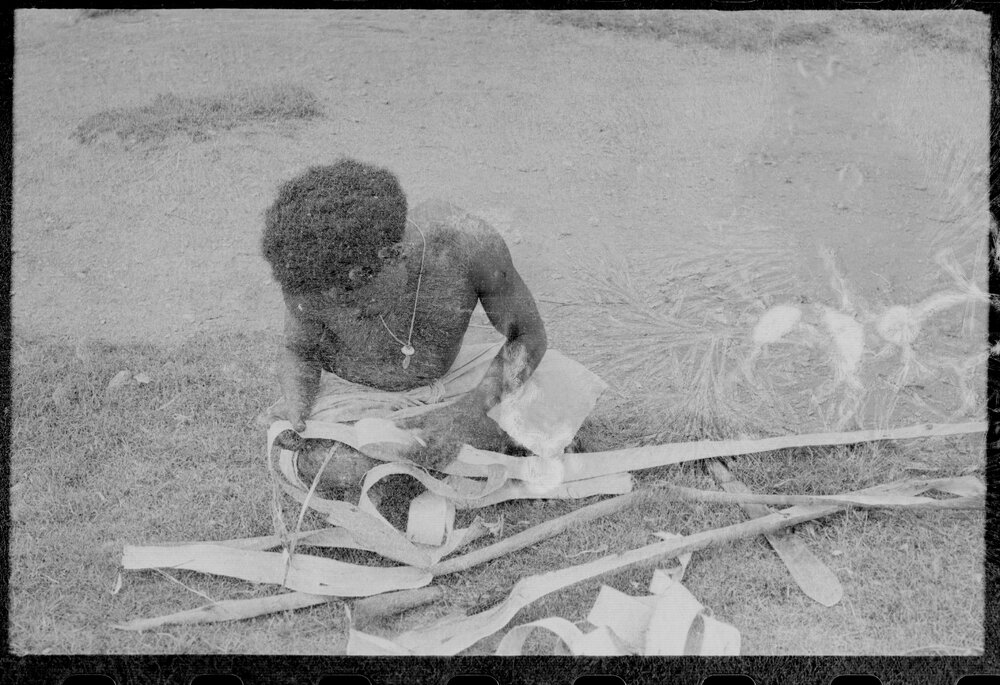 Man Stripping Tree Bark