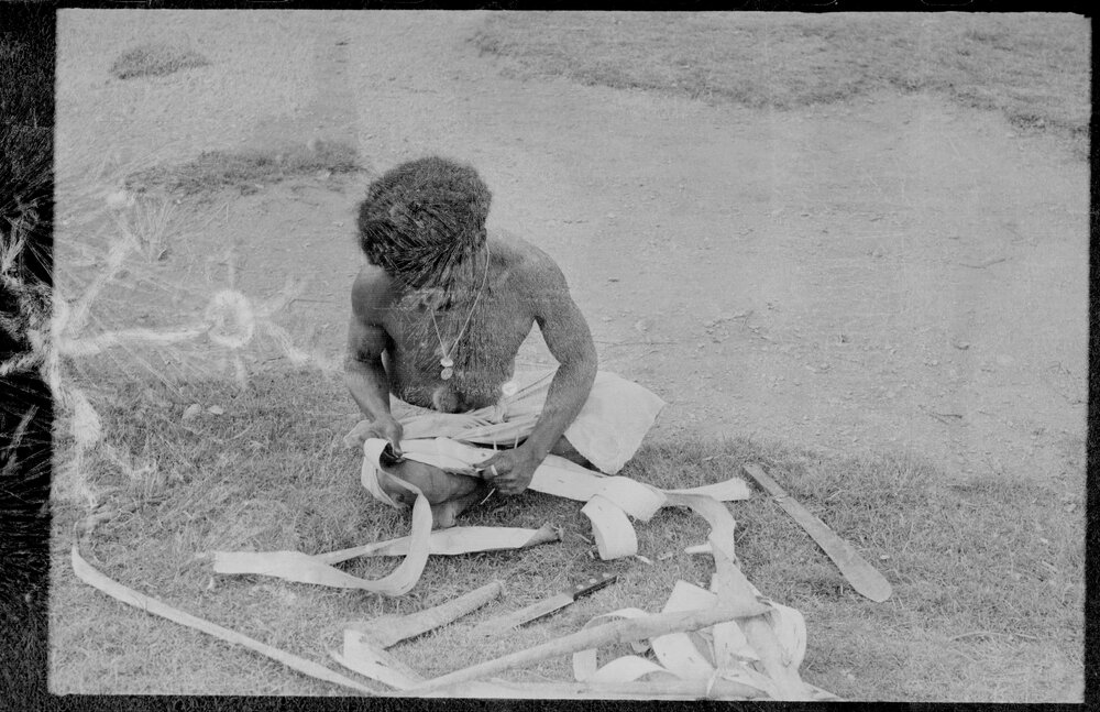 Man Stripping Tree Bark