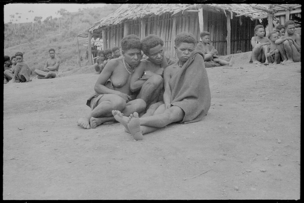 Group Sitting Outside a Building