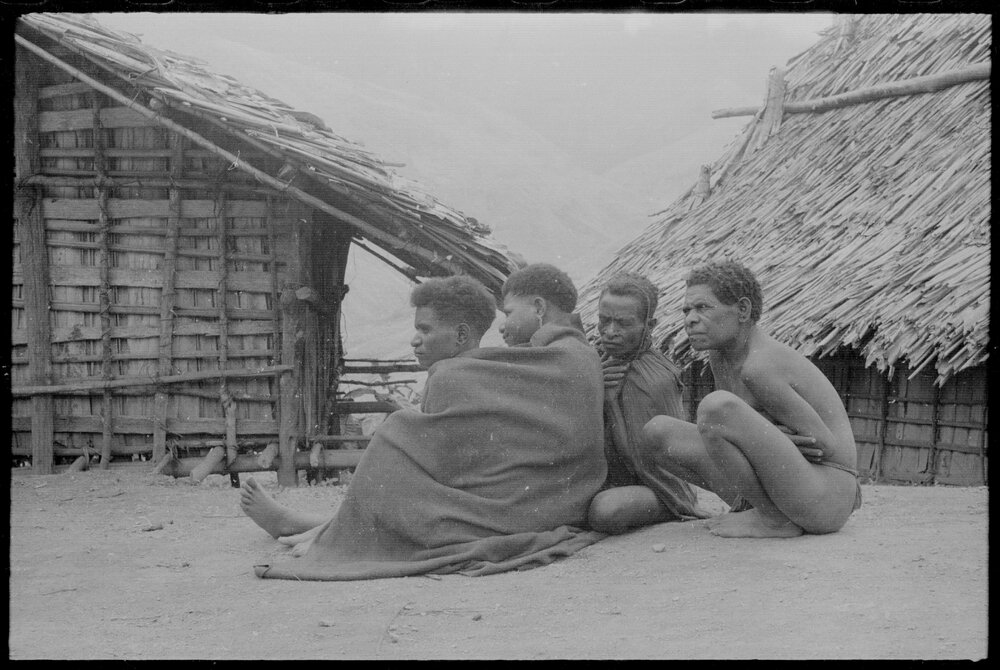 Group Sitting Outside a Building