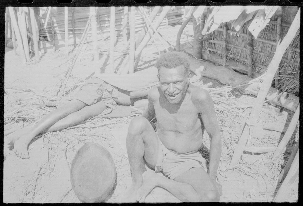 Man Sitting Outside a Building