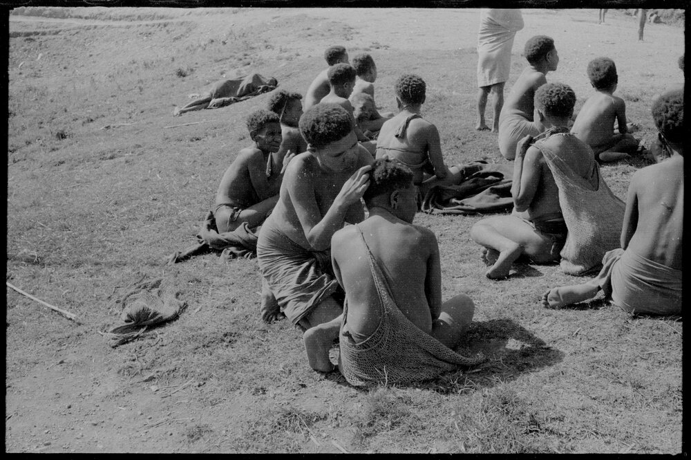Women Sitting, Some with Net Bags
