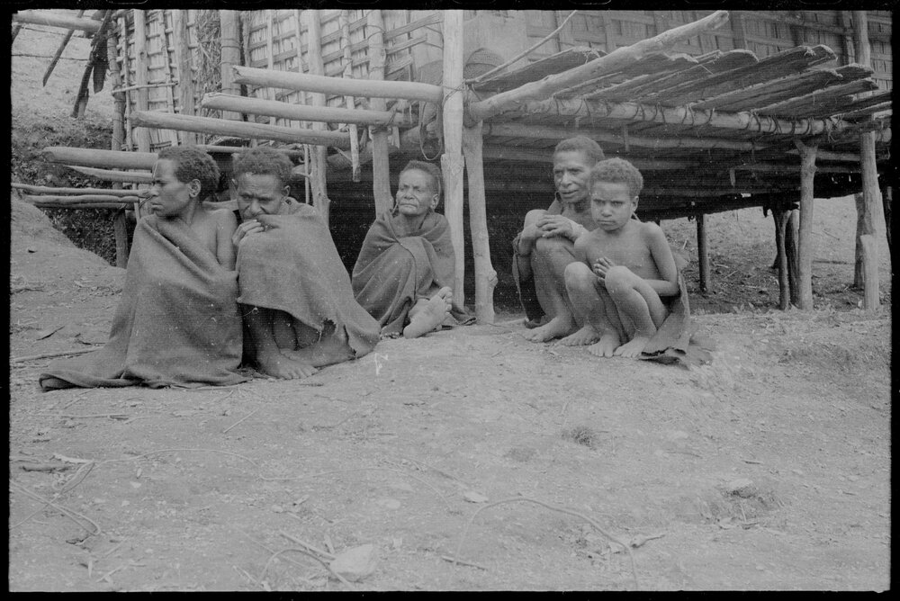 Group Sitting Outside a Building