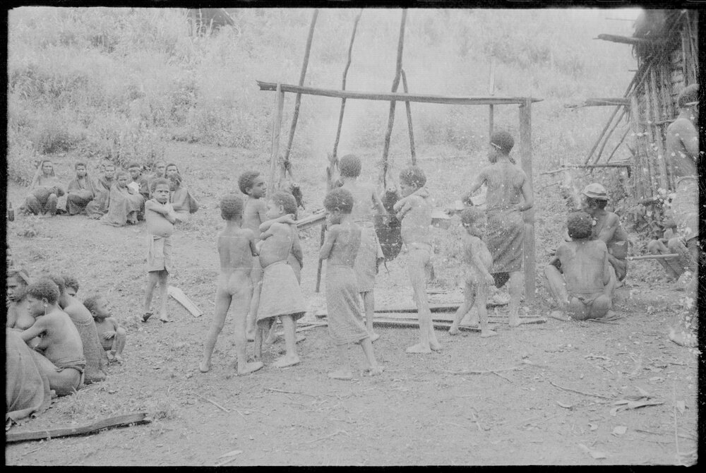 Children Preparing Pigs for a Ceremony
