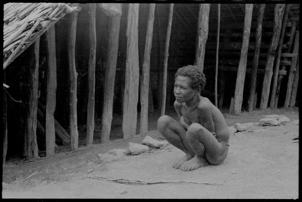 Woman Sitting Outside a Building
