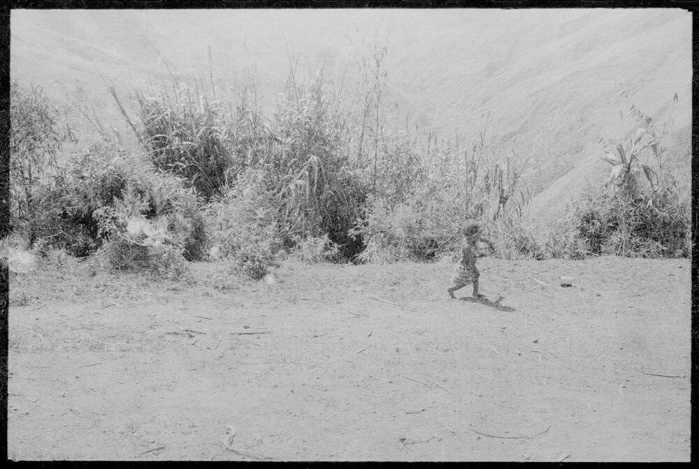 Child Walking on Mountainside Path