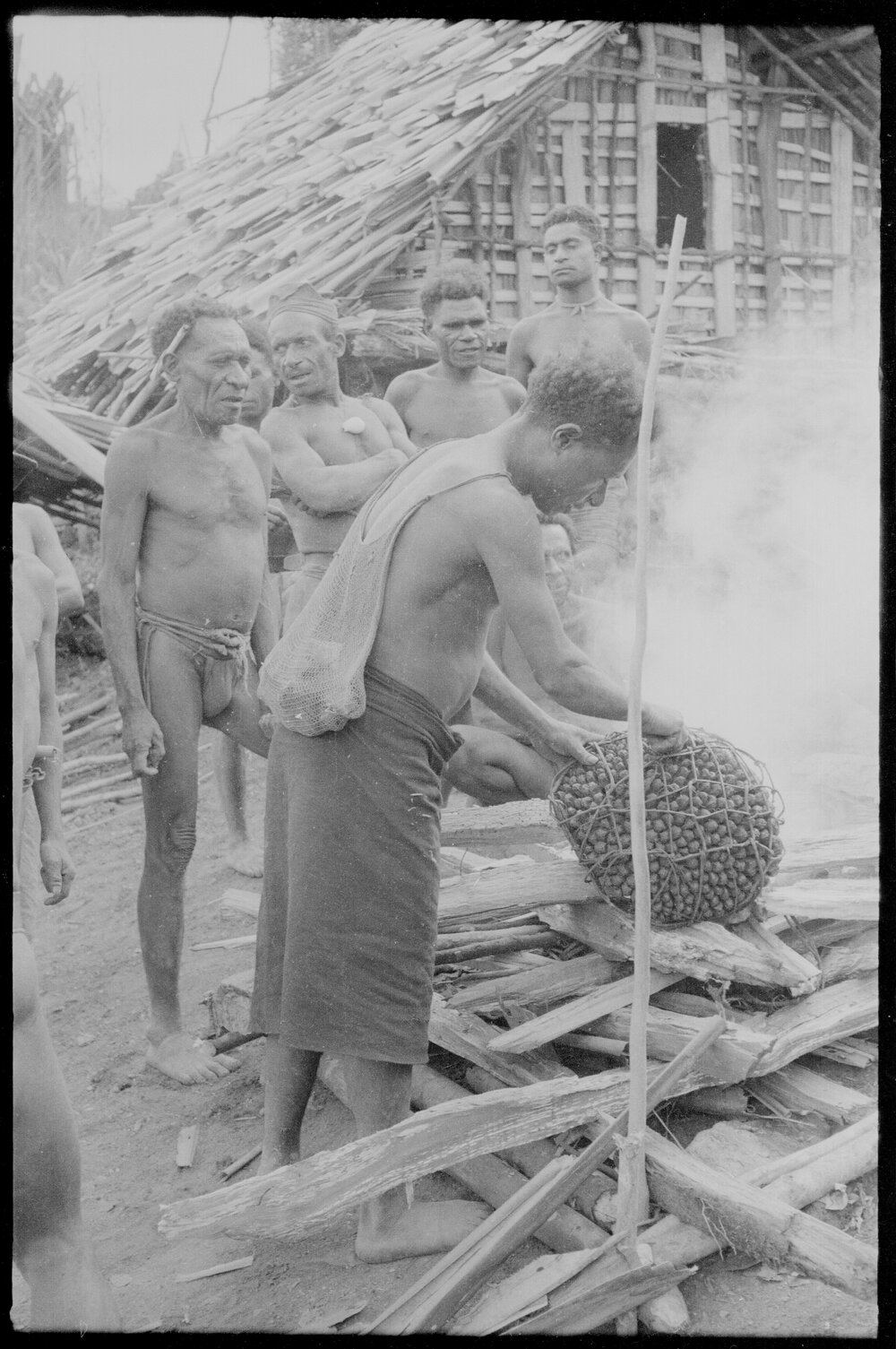 Placing Pandanus Nut on Fire