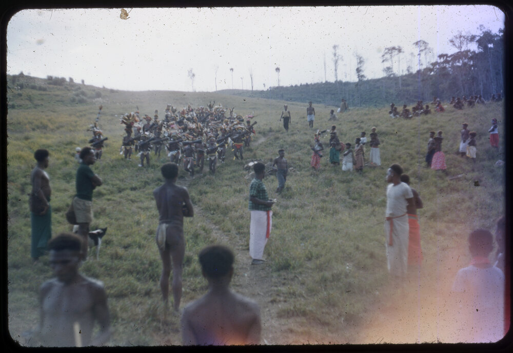 Group with Drums Gathered on Mountainside as Crowd Watches