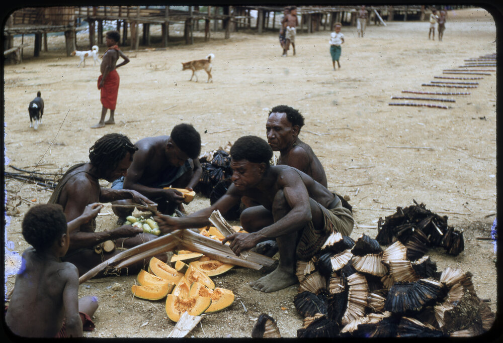Men and Children Preparing Pumpkins