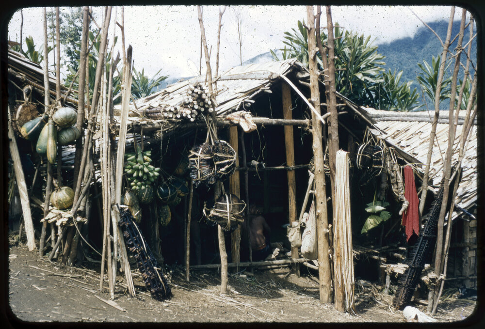 Building with Poles of Plants and Fruits Outside