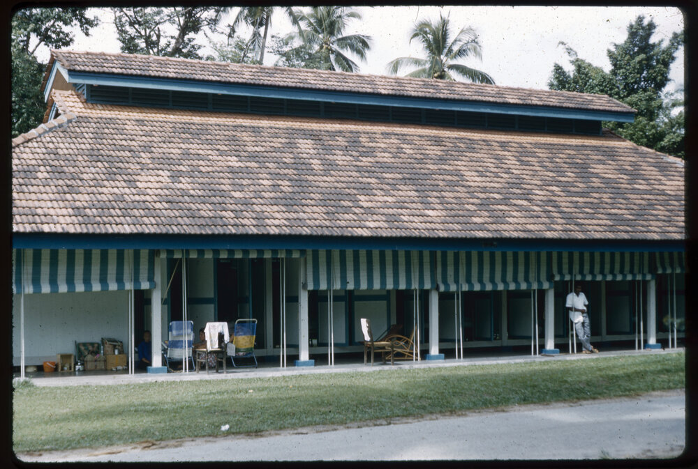 Man Standing Outside a House