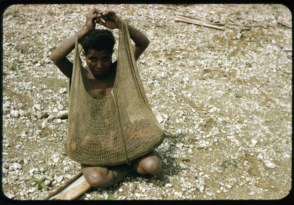 Woman Sitting with Net Bag