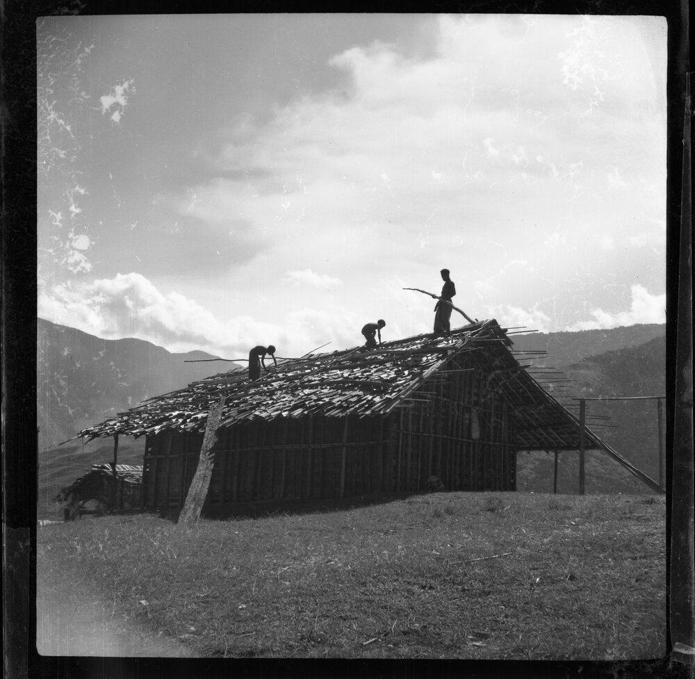 Three Figures Working on a Roof