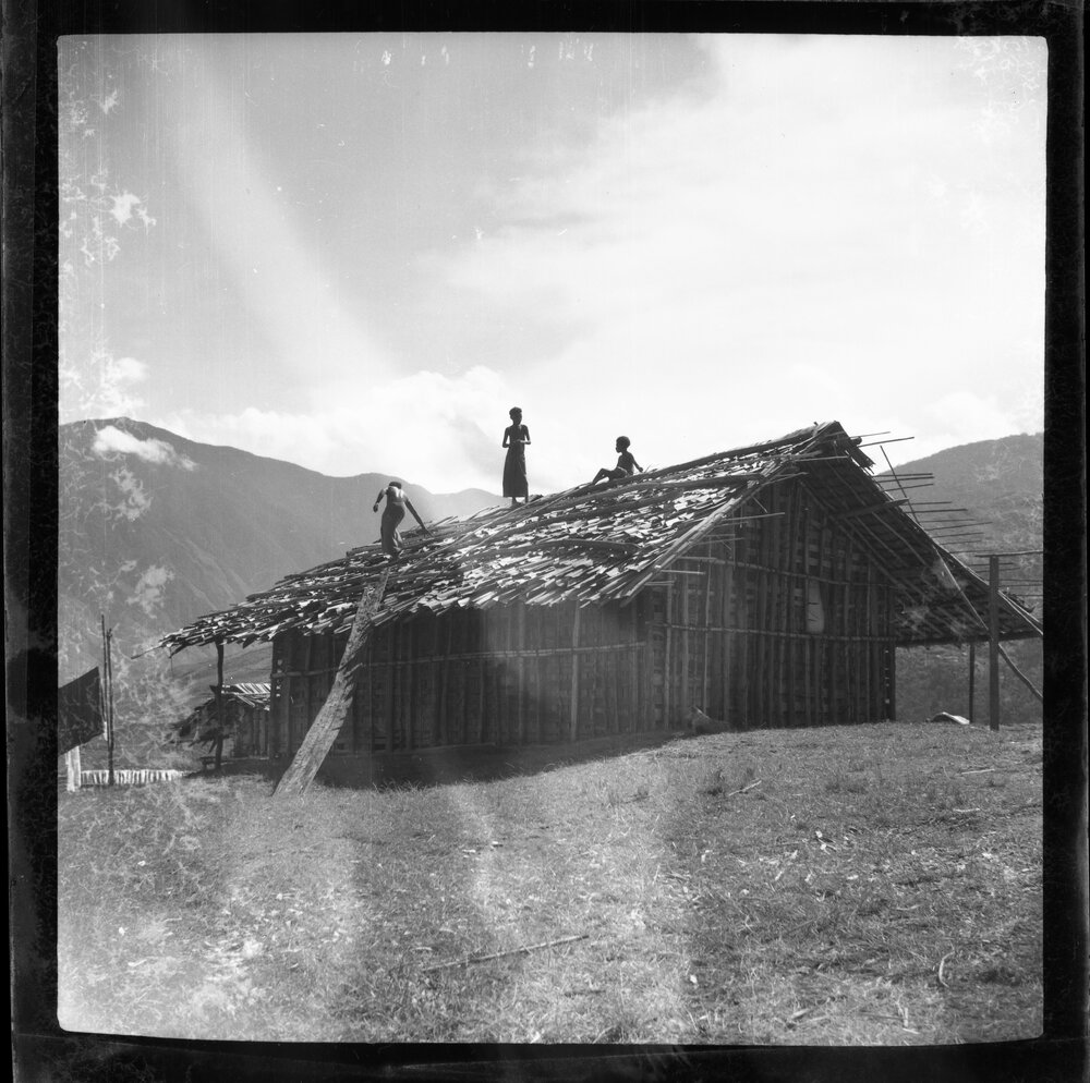 Three Figures Working on a Roof