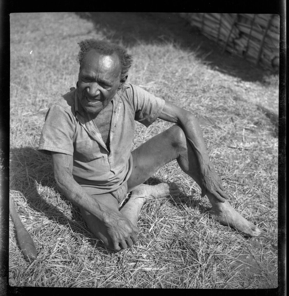 Man Sitting Outside a Building