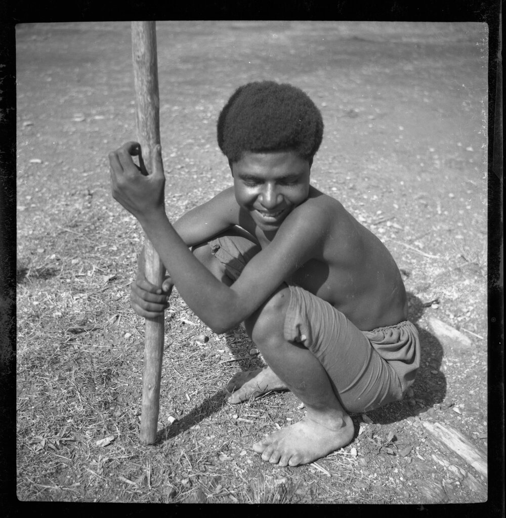 Girl Sitting with a Stick