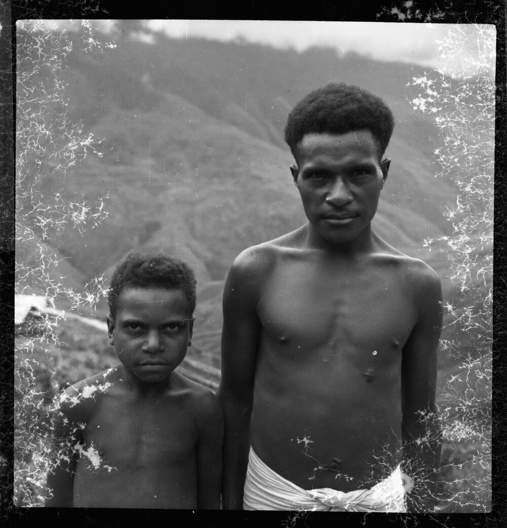 Man and Child Standing on Mountainside