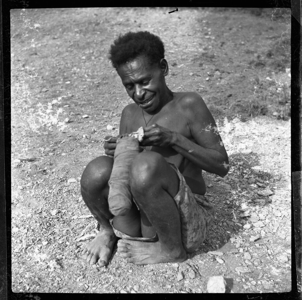 Woman Sitting with Cloth Parcel