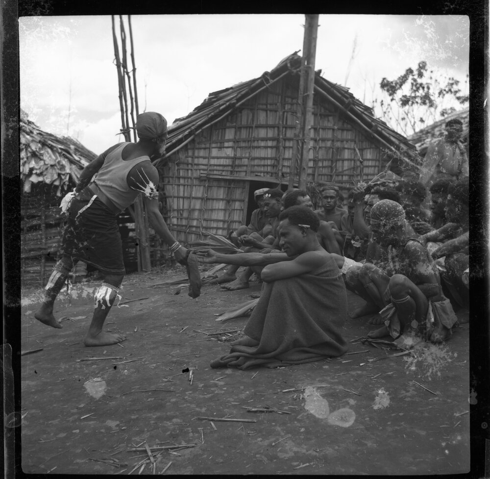 Group Sitting Outside Buildings