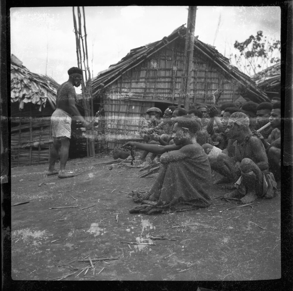 Group Sitting Outside Buildings