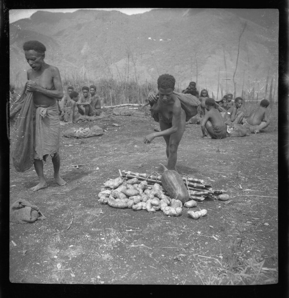 Women Standing with Pile of Vegetables