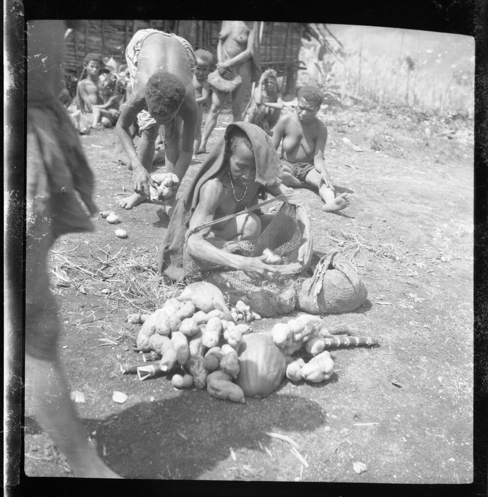 Woman with Net Bag of Vegetables