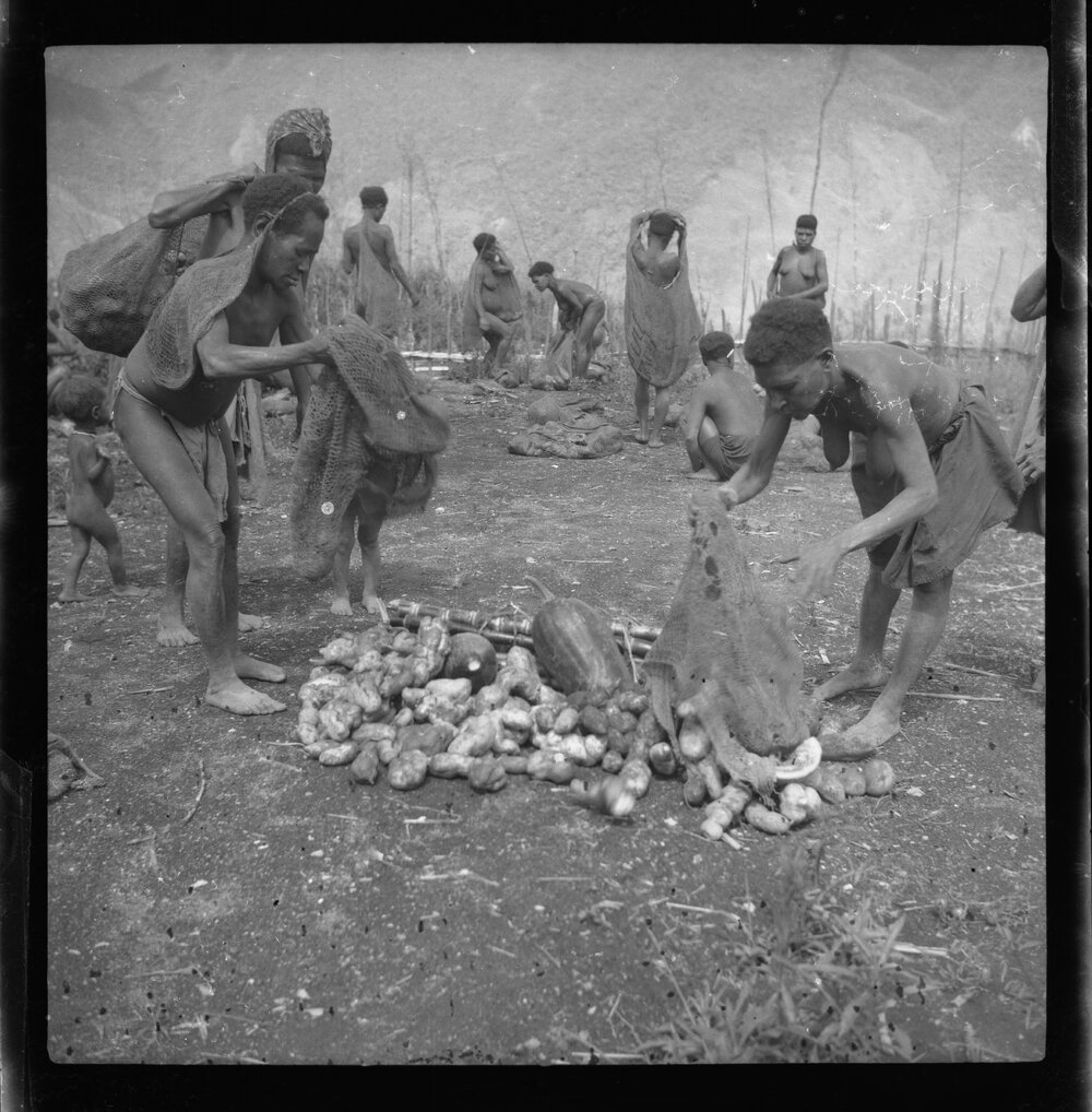 Women Standing with Pile of Vegetables