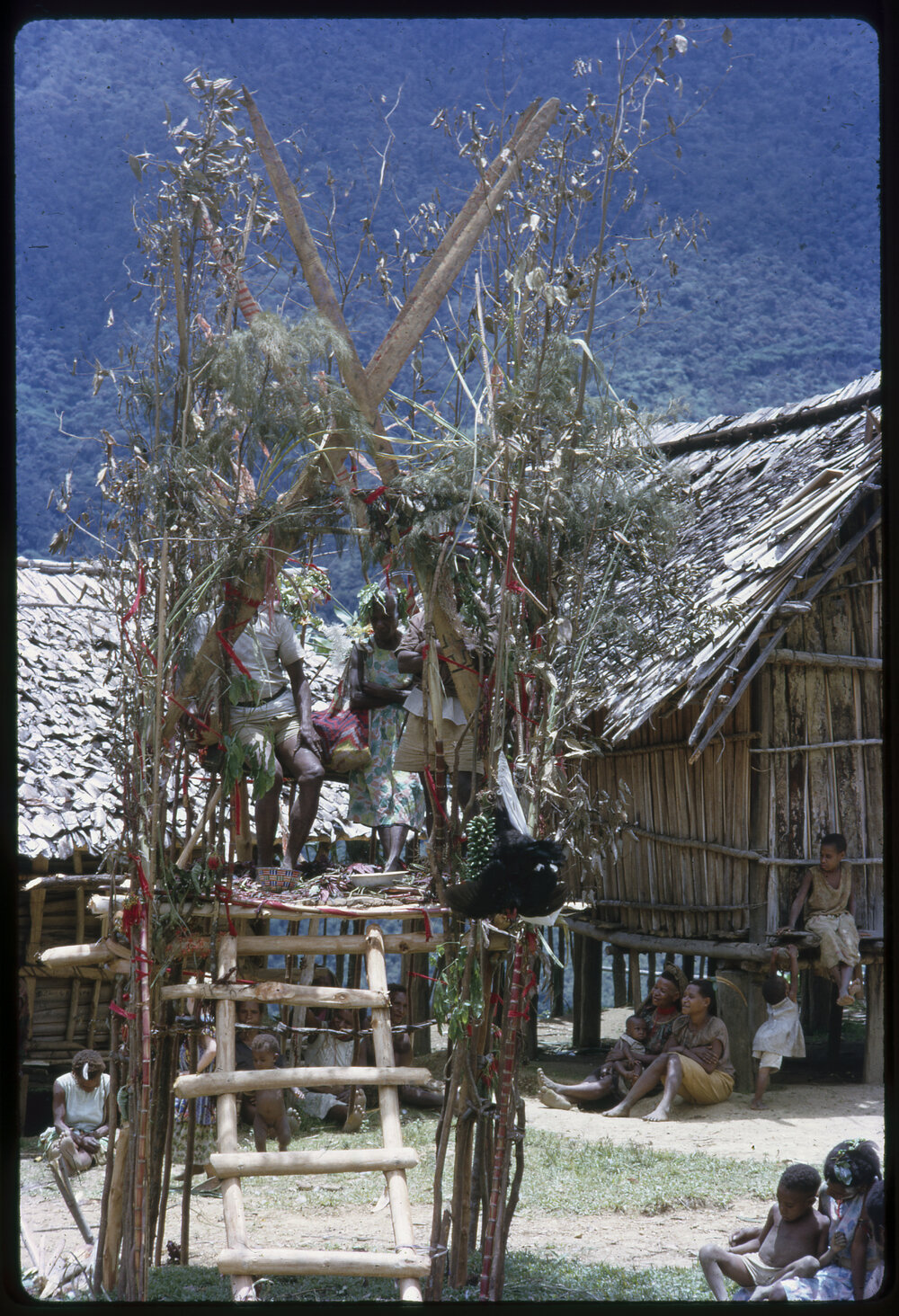 Couple Sitting on Elevated Platform in Village