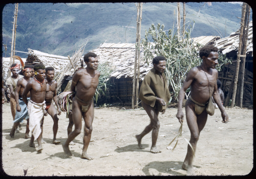 Men Walking Through a Village