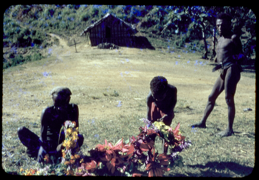 Men and Child Gathering Flowers