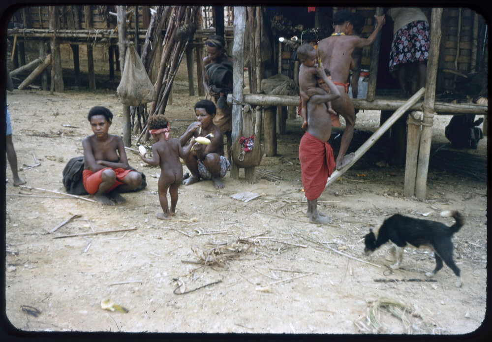 Women and Children Gathered Outside a Building