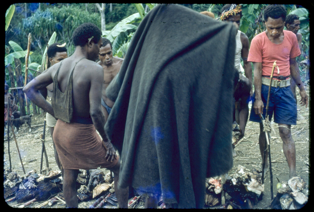 Men Gathered Around Food Piles