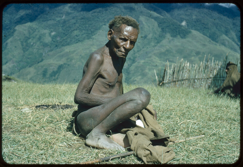 Man Sitting on Mountainside