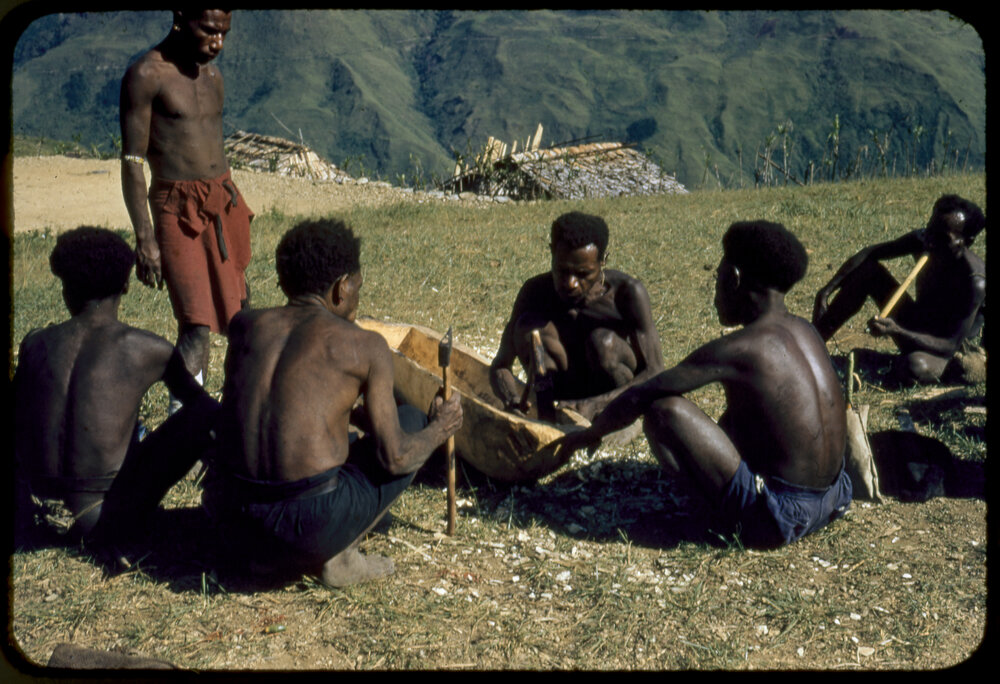 Men Carving a Log
