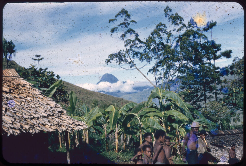 Men and Children Gathered with Mountain in Background