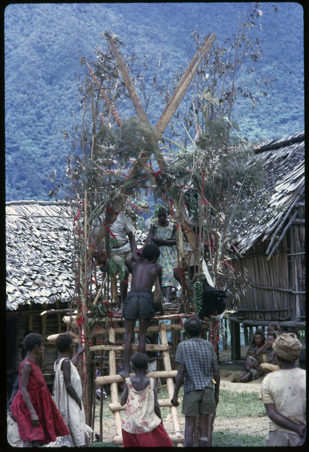 Couple Sitting on Elevated Platform in Village