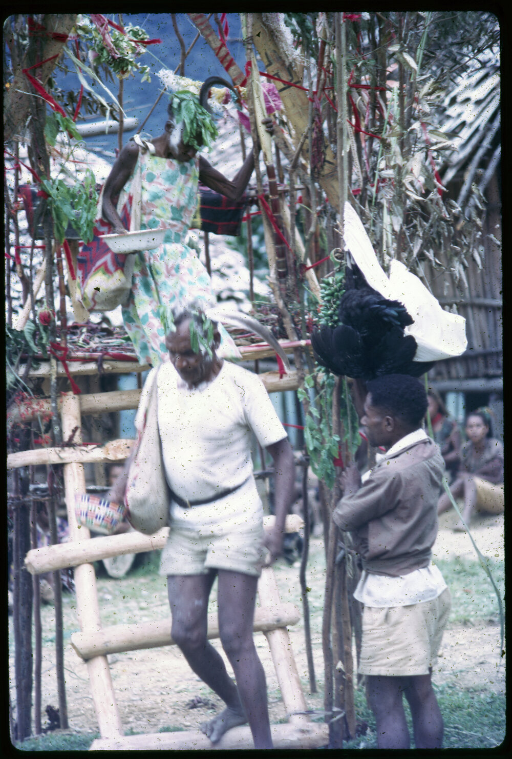 Man and Woman Descending from Elevated Platform in Village