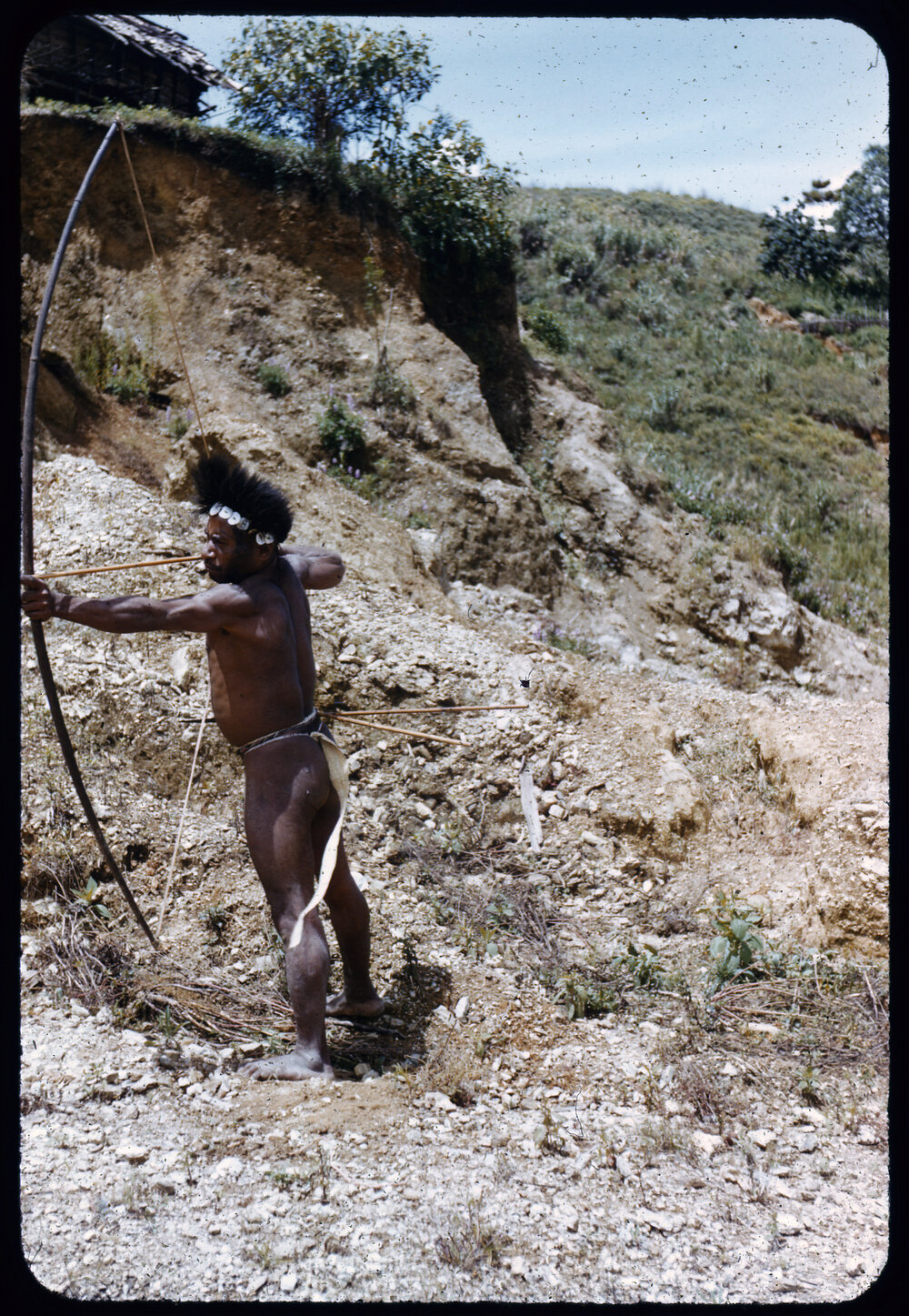 Man Posing with a Bow