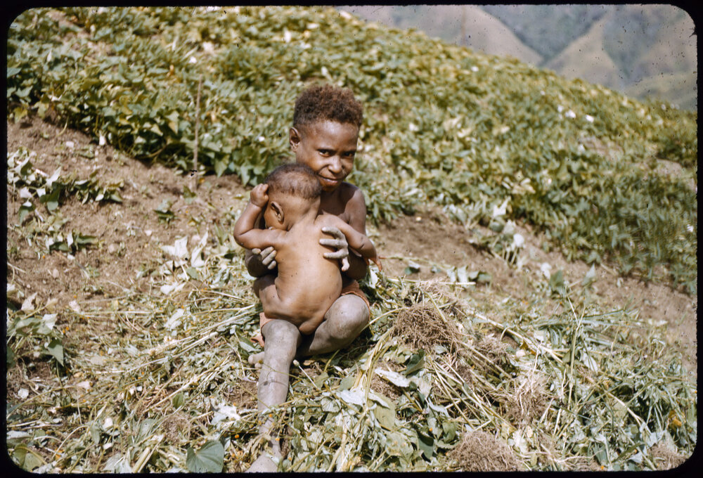 Child Holding a Baby