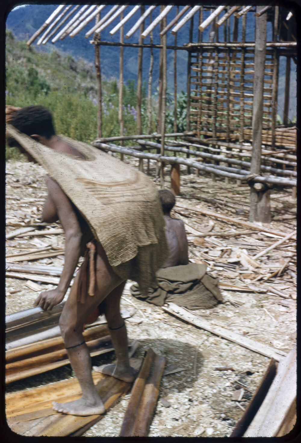 Woman with Net Bag By Partially Constructed Building