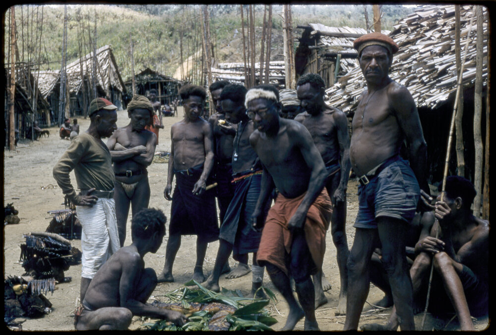 Group of Men Gathered Outside Buildings