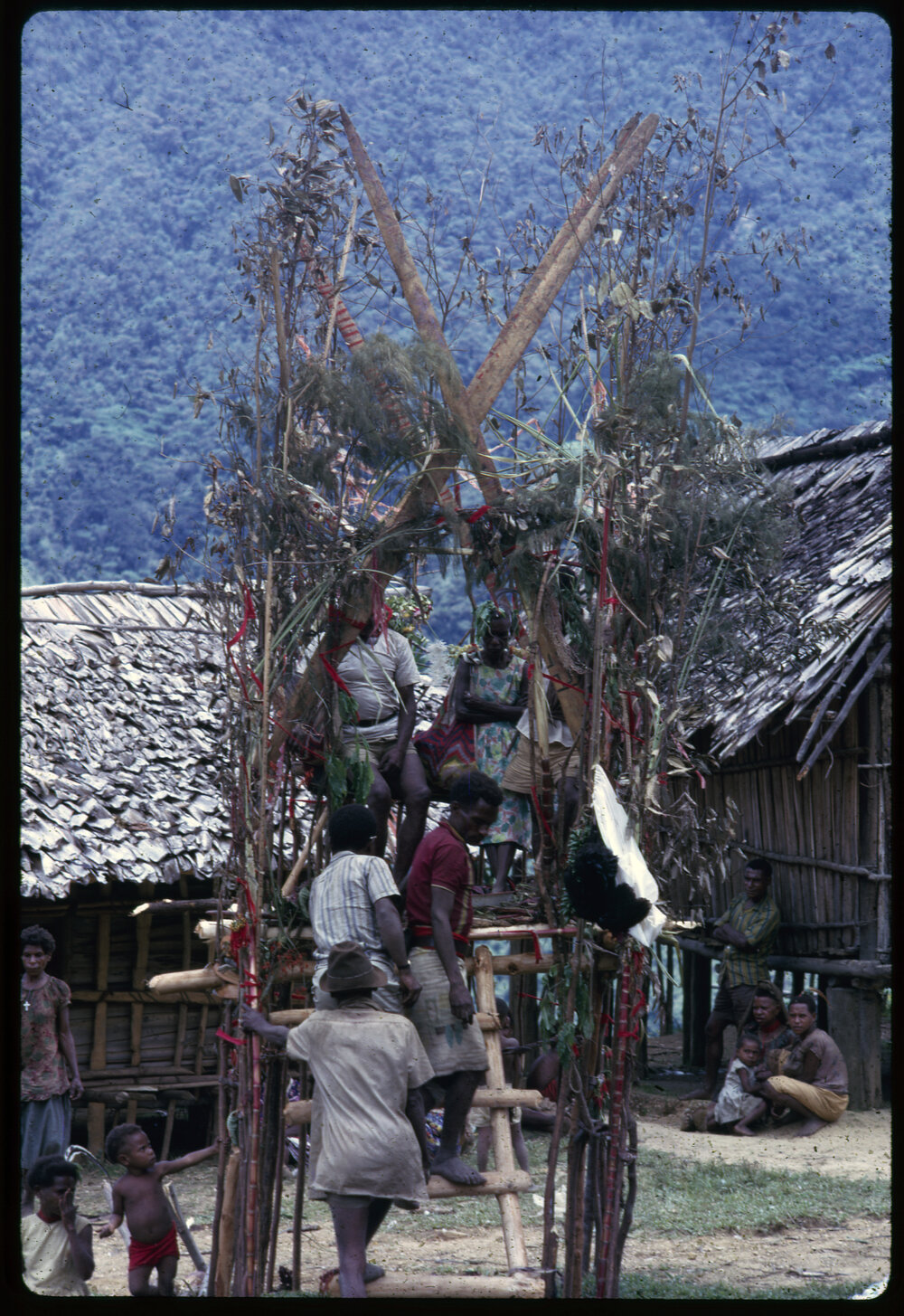 Couple Sitting on Elevated Platform in Village