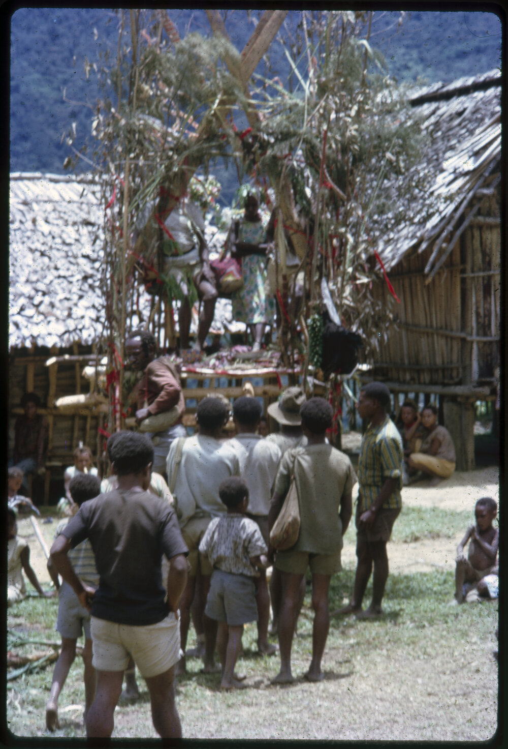 Couple Sitting on Elevated Platform in Village