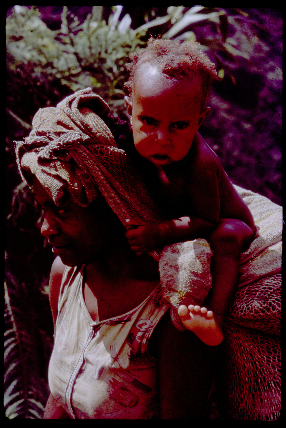 Woman Carrying a Net Bag and Baby