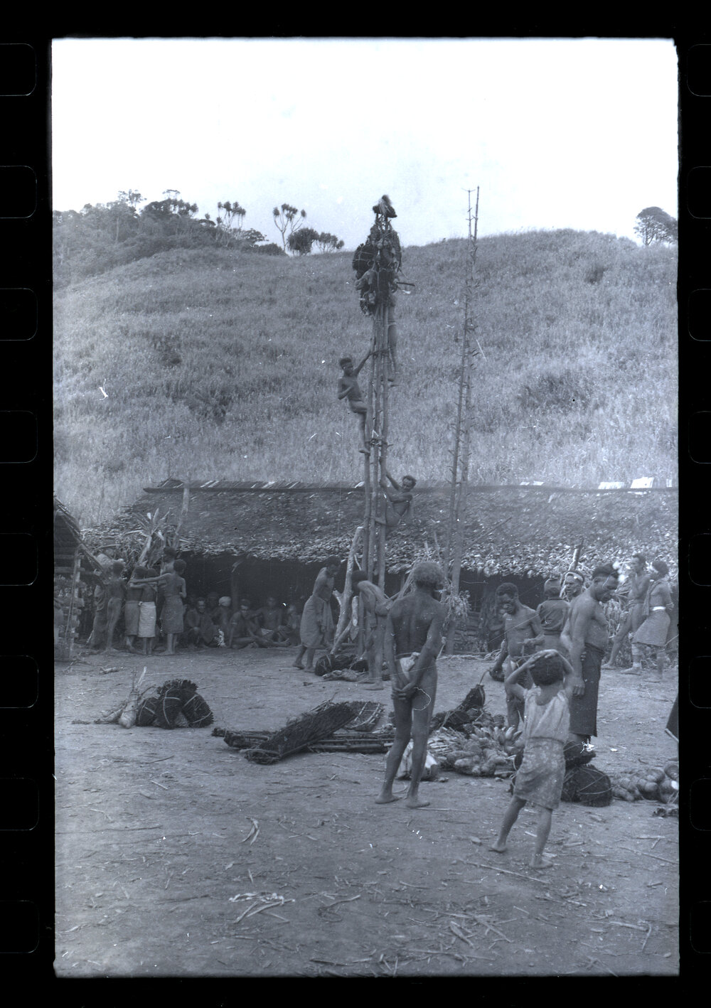 Men Climbing Food Pole