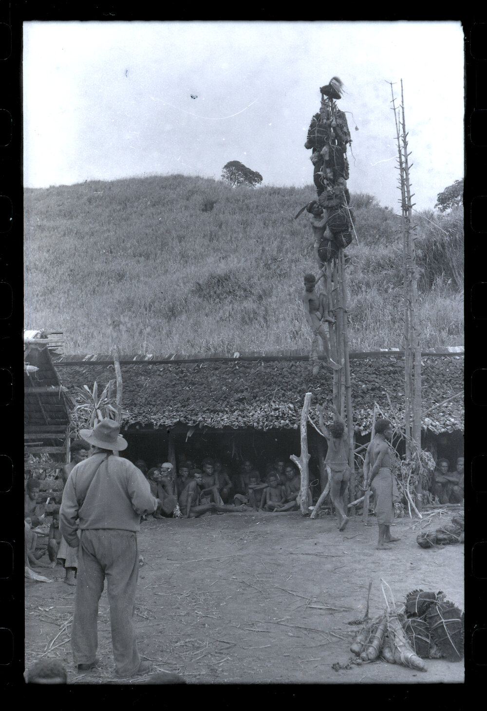 Men Climbing Food Pole