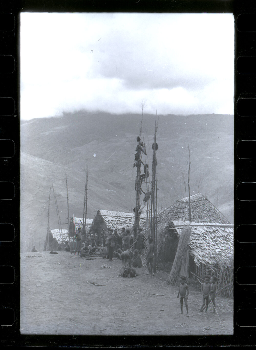 Men Climbing Food Pole