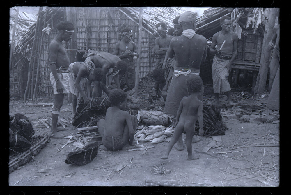 Men Preparing Bundles of Food