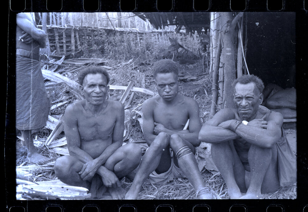 Men Sitting Outside a Building