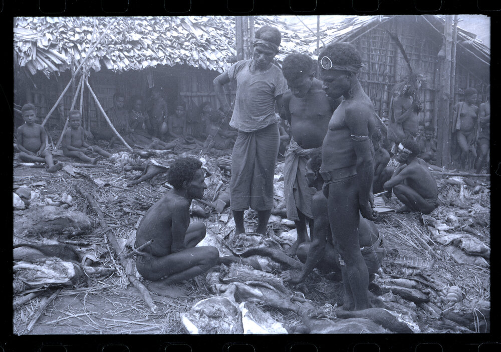 Men Standing with Butchered Pigs
